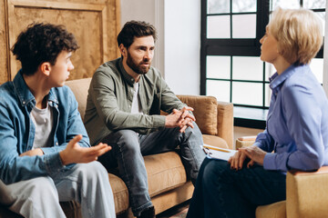 Father and teenage son consulting problem mental health with psychologist