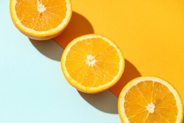 Composition with ripe tasty halves of oranges on color background, closeup
