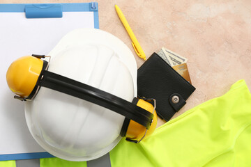 Safety equipment, protective vest, clipboard and wallet on color background, closeup