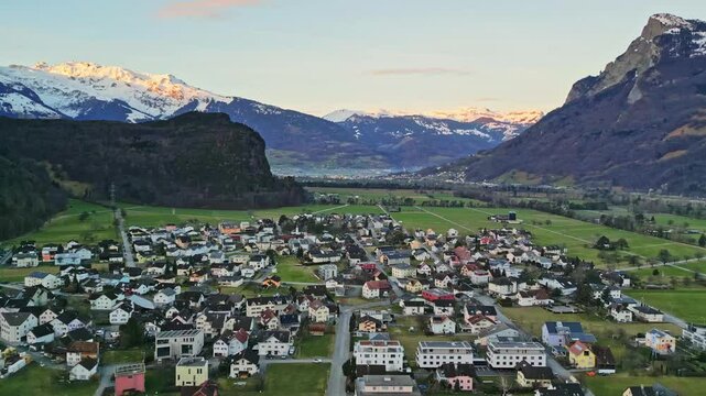 Aerial footage of beautiful valley in the Alps during spring at sunrise Liechtenstein and Switzerland