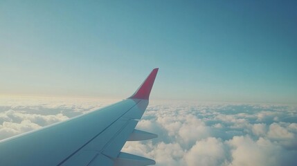 Stunning view of airplane wing flying above the clouds — perfect for travel blogs, airline promotions, wanderlust-themed content, and vacation or adventure marketing projects