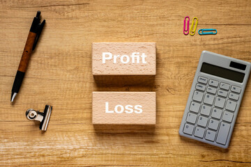 There is wood block with the word Profit or Loss. It is as an eye-catching image.