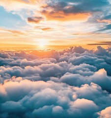 Fototapeta premium Sunrise over the sea of clouds, rolling mountains , golden sky, distant sun setting behind the horizon