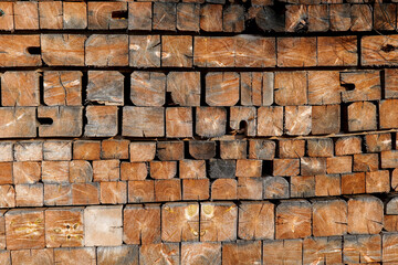 Stacked Wooden Planks with Textured Surface. Rustic vintage background. Square wooden bars wallpaper. Vintage old bars background. Wooden texture in gray and brown tones.Wooden geometric surface.