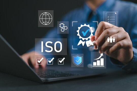 ISO certification and quality management concept. Businessman reviewing ISO certification standards with digital icons representing quality control, management, and compliance processes. - Powered by Adobe