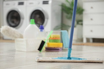 Mop on floor in laundry room, closeup