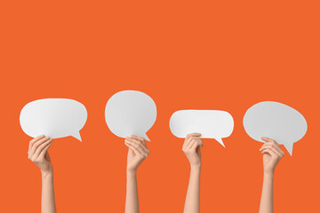 Female hands with speech bubbles on orange background
