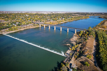 Bridge spans a river with a green waterway below