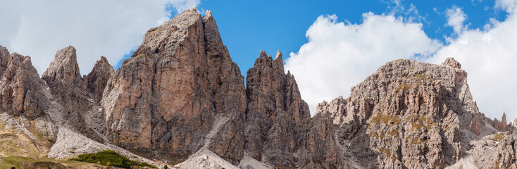 Majestic mountain peaks under clear blue sky near Valley of Funes at Dolomites, Italy.