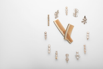 Clock shape made of combs and hair clips on white background, flat lay. Space for text