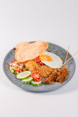A plate of food with a piece of fried egg on top. The plate is blue and white