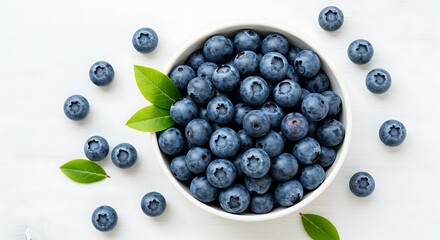 A top view of fresh blueberries in a bowl, isolated on a white background. The deep blue color of the berries stands out against the clean, minimalist setting, offering a fresh and inviting appearance