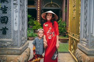 Fototapeta premium happy woman mother with son tourists travelers at a Buddhist temple in Vietnam in Asia