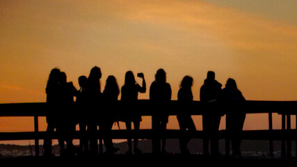 Crowd at waterfront boardwalk at sunset time, punta del este, uruguay