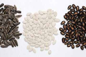 Roasted pumpkin seeds on white background.