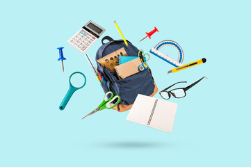 Set of office
school supplies falling in the air on light green background.