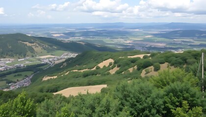 Obraz premium Expansive vista from elevated vantage point showcasing diverse terrain layers