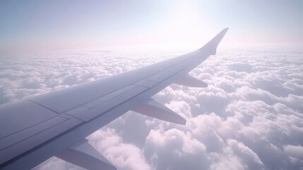 Obraz premium Airplane Wing Above the Clouds in a Clear Sky