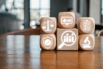 Wooden blocks with digital icons representing data analysis, business intelligence, and technology solutions on a wooden table.