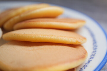 Fluffy pancakes stacked on a plate ready for breakfast