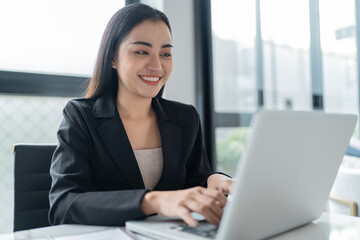 Beautiful&nbsp;confident asian business woman working with laptop Hands typing  keyboard. Professional investor working new start up project. business planning in office. Technology business