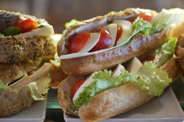 Freshly made sandwiches filled with lettuce and tomatoes in cafe