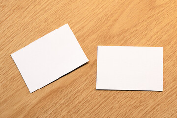 White blank business card mockup with wooden decoration on wooden background