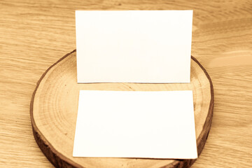 White blank business card mockup with wooden decoration on wooden background