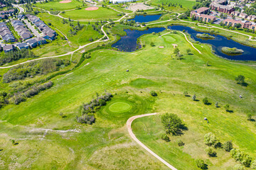 Golf course with a pond and trees in the background