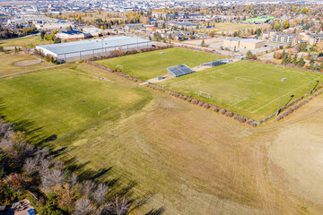 Large field with a stadium in the background