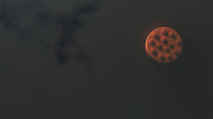 Orange studded disc against a dark, cloudy backdrop, ideal for abstract or minimalist designs