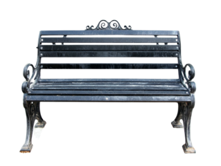 Ornate metal park bench with a vintage flair against a stark black backdrop