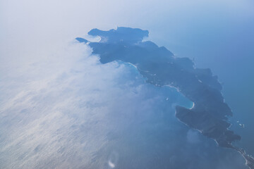 View of a Serene Coastal Island Surrounded by Blue Ocean