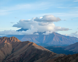 Serene Mountain Vista, Clouds Dance Above Rugged Peaks in a Breathtaking Landscape under a vast, expansive Sky, inviting exploration and tranquility