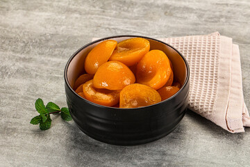 Sweet canned apricots with syrope