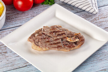 Grilled lamb steak with bone