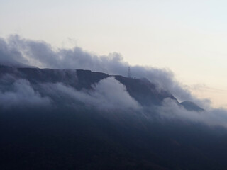 Obraz premium A soft layer of morning fog wraps around Mount Dalara in Coron, Palawan. Captured just after dawn with calm skies and subdued mountain tones.