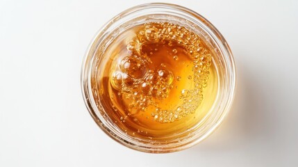 Golden liquid in a small glass bowl