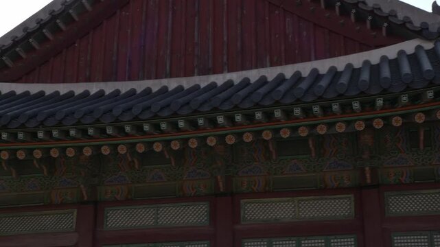 Traditional Korean Palace Roof With Ornate Dancheong Patterns And Curved Eaves. closeup, panning shot