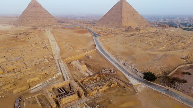 Giza Necropolis - Great Pyramid, Pyramid of Khafre, Pyramid of Menkaure With Great Sphinx In Cairo, Egypt. - aerial shot