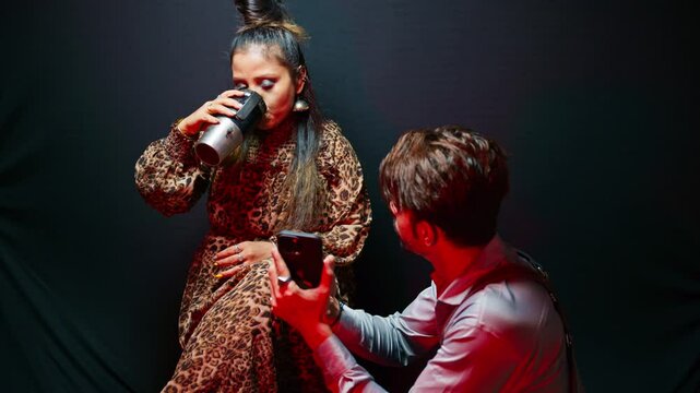 Fashion expert directs model for next frame at studio