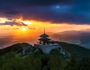 Fototapeta premium Temple on top of the mountain, on a background with dramatic lighting, colorful mountain sunset, dark clouds and sky and sunbeams.