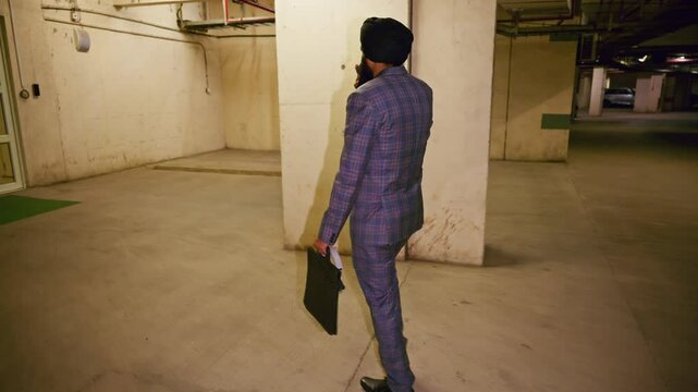 Executive in formal attire strides through lower level