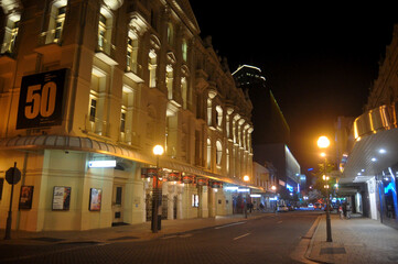 Australian people walking on pavement in night time at St Georges Terrace Street in Perth, Australia
