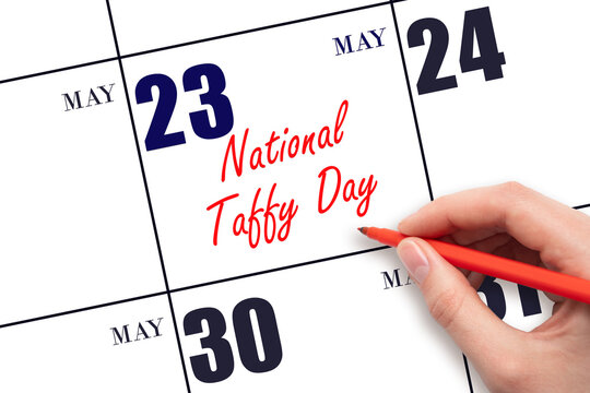 May 23. Hand writing text National Taffy Day on calendar date. Save the date.