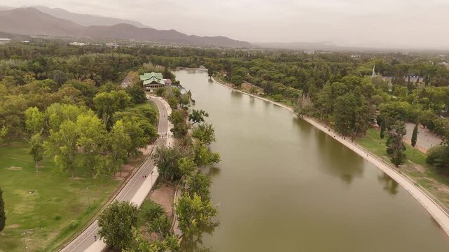 4K 60fps aerial footage over the lake in Parque General San Martin, Mendoza, Argentina. Features the Andes mountains in the background
