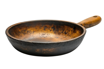 A rustic vintage cast iron skillet with a worn wooden handle showing signs of age and use against a black background a testament on transparent background
