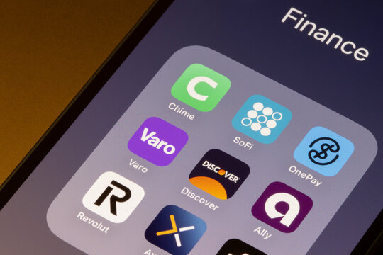 Portland, OR, USA - Apr 21, 2025: Assorted mobile banking apps, including Chime, SoFi, OnePay, Varo, Discover, Ally, Revolut, and Axos, are seen on the seen of an iPhone.