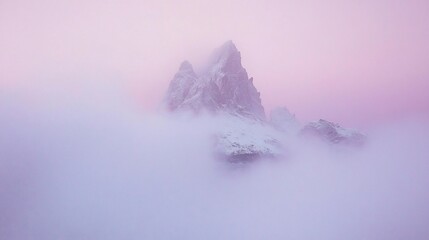 Majestic peak shrouded in ethereal pink mist