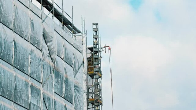 Industrial Scaffolding Secured with Safety Net Tarp at Multi Storey Residetial Building Construction Site